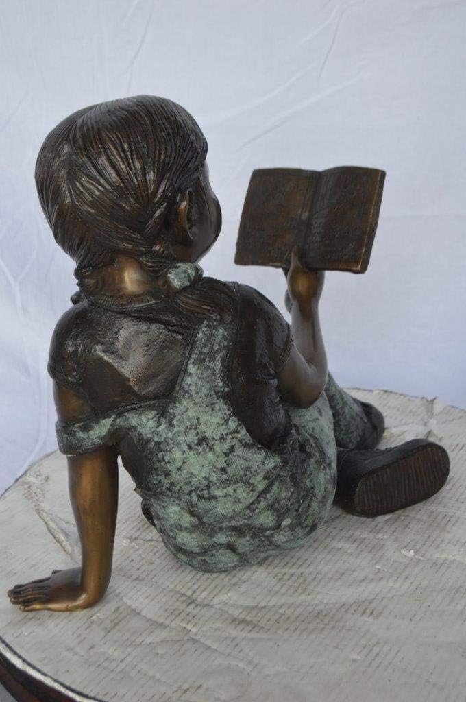 Young Girl Laying and Reading Book Bronze Statue - Size: 18" L x 9" W x 16" H.
